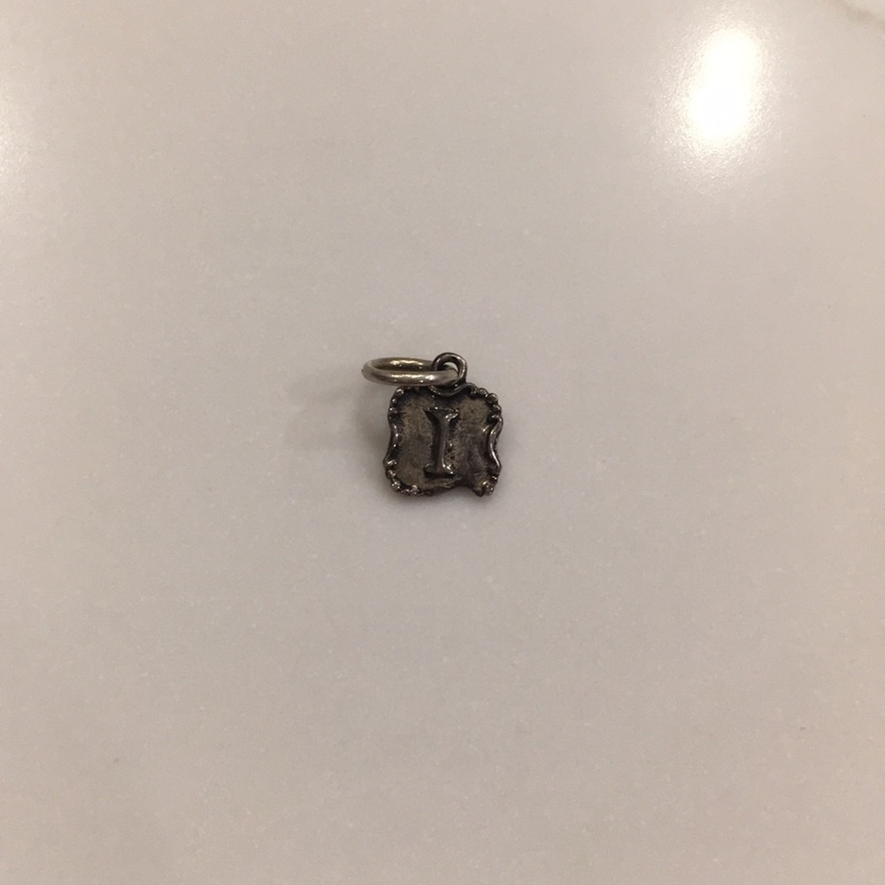 Insignia crest waxing poetic charm “I”